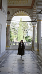 Young woman touring the historic topkapi palace in istanbul, a symbol of ottoman architecture