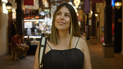 Smiling young woman enjoying a visit at the traditional souk in dubai, showcasing diverse culture and tourism.