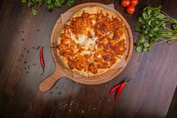 khachapuri with sulguni cheese, herbs and egg on a wooden surface. Georgian pie. Georgian pizza
