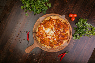 khachapuri with sulguni cheese, herbs and egg on a wooden surface. Georgian pie. Georgian pizza

