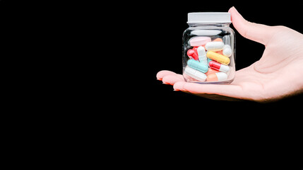 Pharmaceutical Industry Hand Holding Colorful Capsules in a Pharmacy Setting. This image captures the essence of the pharmaceutical industry with a hand holding capsules, symbolizing production.