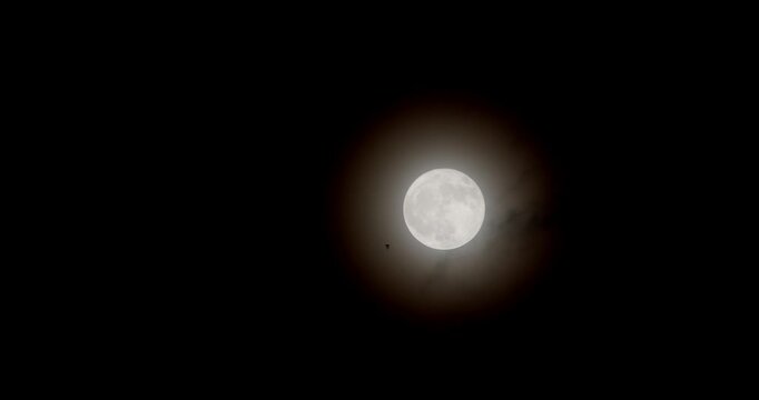 Full moon.Mooon light in cloudy sky.Full glowing mooon in cloudy night.