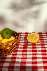Lemons and Limes on a Gingham Tablecloth with Shadow Play in the Background