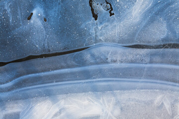 A close-up of ice, revealing intricate crystalline patterns and textures