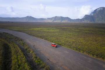 Driving at the sand dunes in the desert at the feet of Mt Bromo