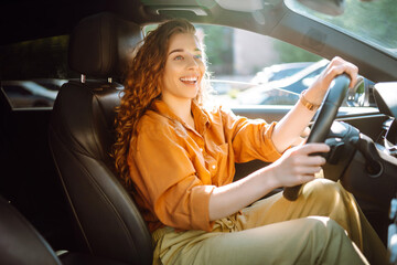 Portrait young woman driving car. Young traveler driving. Car travel, lifestyle concept.