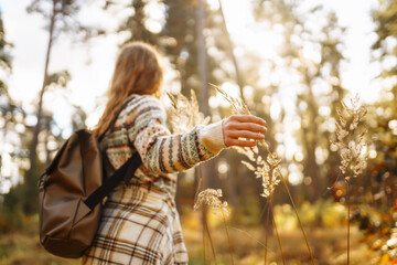 Hello autumn. Woman tourist enjoys autumn nature. People, freedom, lifestyle, travel and vacations concept.