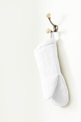 Oven mitt png mockup, white kitchen wall