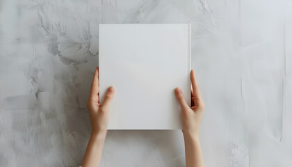 Woman holding brochure with blank cover on grey background, top view. Mock up for design