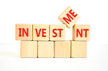 Investment symbol. Concept word Investment on beautiful wooden blocks. Beautiful white background....