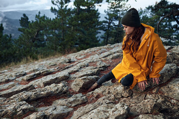 A woman enjoying the solitude of nature in the majestic mountains on a rainy day