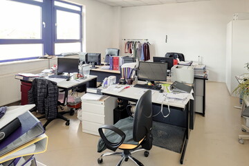 Messy office room of a closed down factory, no people