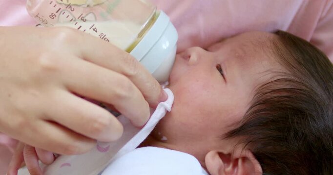 Detail of mother breastfeeding her newborn child.