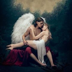 Winged male angel embraces tender woman against vintage background. Sense of tenderness and protection, blending divine with human. Concept of history, mythology, love and passion, comparison of eras