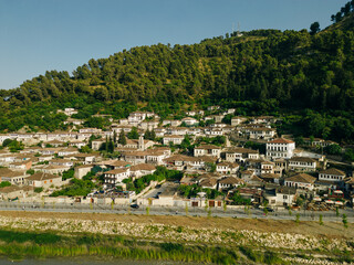 Obraz premium BERAT, ALBANIA, April 13, 2024: Berat castle viewed from boulevard Republika in Albania