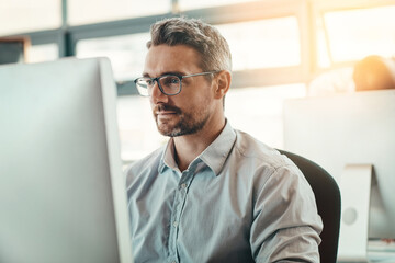 Mature man, business and computer in office for creative design, online feedback and information of...