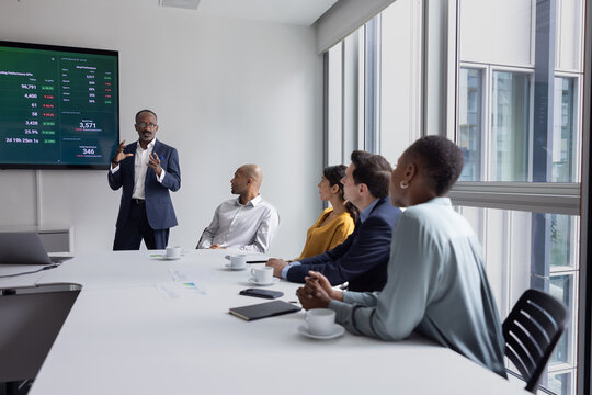 CEO of a company giving a presentation to his employees in a conference room