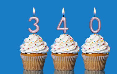 Birthday Cupcakes With Candles Lit Forming The Number 340
