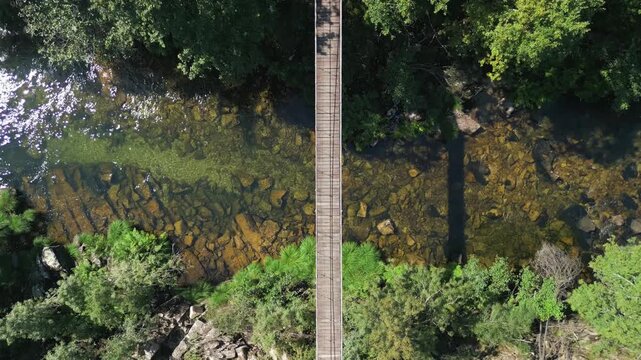 Wooden Footbridge Of Ponte Colgante de Calvelo Over River Lerez In Pontevedra, Spain. Aerial Topdown Shot