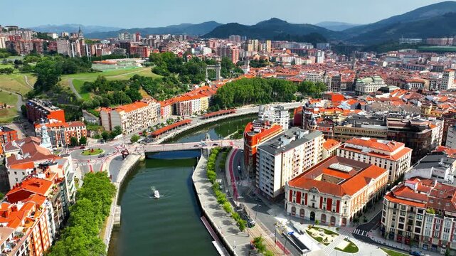 aerial view of Bilbao cityscape with a bridge and Nervion river in Bilbao, Basque Country, Spain. Idyllic town in Northern Spain, drone view of downtown Bilbao