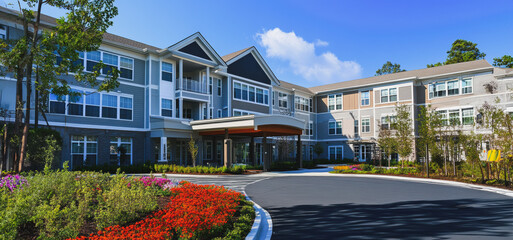 Modern Residential Building Surrounded by Colorful Garden in Bright Daylight