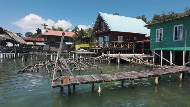 View of stilt houses and docks on Bastimentos Island in Bocas del Toro, Panama. Scenic waterfront architecture and tropical surroundings.