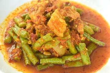 spicy stir fried slice yard long bean with fat pork and lemon grass in curry sauce on plate