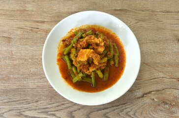 spicy stir fried slice yard long bean with fat pork and lemon grass in curry sauce on plate