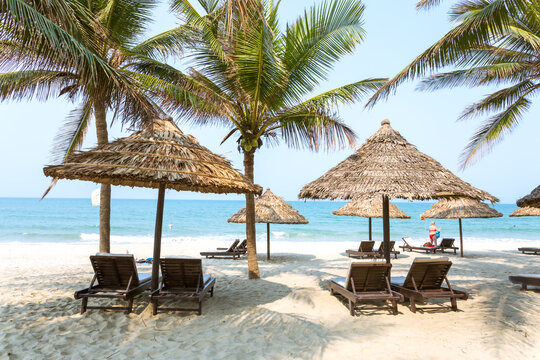 Tropical beach with sunshades and lounge chairs, Hoi An, Vietnam