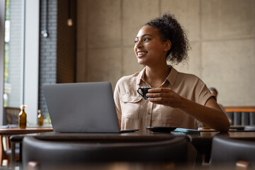 Young female freelancer working from a cafe
