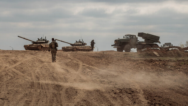 Two T-72 tanks, Grad MLRS and soldiers on a military road. Russian Army.