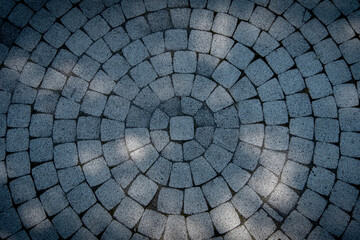 A pattern in the form of circles of stones, a paved road. A historical feature. Flat square stones...