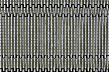 A metal plate made of curved lines and vertical stripes