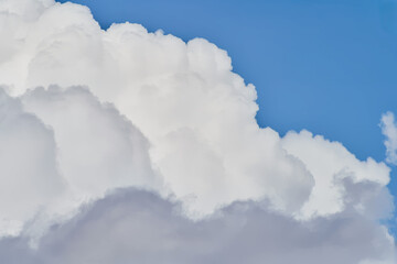 White cumulus clouds against azure sky