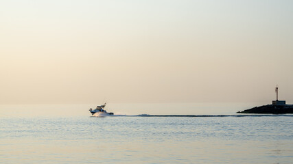 Fototapeta premium fishing boat at sunset