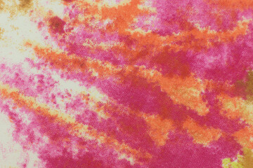 Abstract texture background made of fabric. Macro. Spotted background in red-orange color for design.