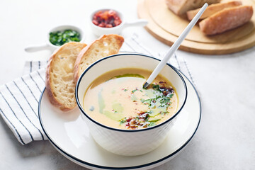 Bowl of potato soup with parsley and bacon with toasted bread croutons in white bowl. Comfort meal