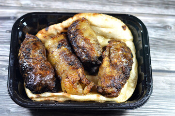 Tarb Middle Eastern Arabic cuisine traditional food beef Kofta, kebab and tarb kofta shish which is minced meat, Arabian oriental grilled barbecued meat food on Egyptian Aish pita bread