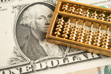 Gold abacus on US dollar banknote money, economy finance exchange trade investment.