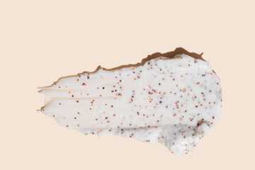 Stroke of homemade body scrub smear with coffee grains on beige background. Skin care exfoliation cosmetic product presentation.