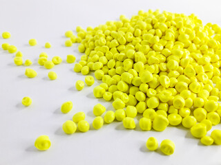 Neon yellow masterbatch granules on white background.Color pigment carrier polymer in plastic...