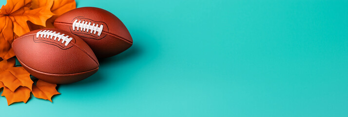 Autumn leaves and footballs on a teal background symbolize the intersection of fall season and Thanksgiving sports traditions