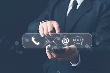 Concept of contact us, customer support, service, icon, Contact us or Customer support hotline people connect. Businessman using a laptop with the (email, call phone, mail) icons. customer service.