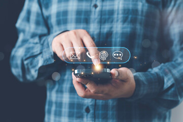 Concept of contact us, customer support, service, icon, Contact us or Customer support hotline people connect. Businessman using a laptop with the (email, call phone, mail) icons. customer service.