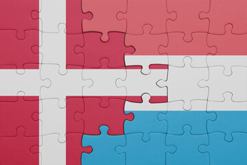 puzzle with the colourful national flag of luxembourg and flag of denmark.