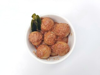 Indonesian food cilok bumbu kacang is a food made from flour and sago with peanut sauce isolated on white background 