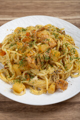 angle view spaghetti with chicken and potato curry sauce at vertical composition