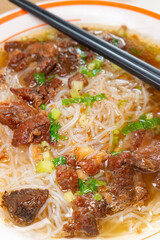 top view rice noodles with braised beef brisket at vertical composition