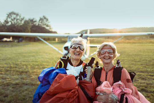 Portrait of a two happy senior women smiling after skydiving