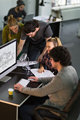 Team of architects collaborating on project in modern office